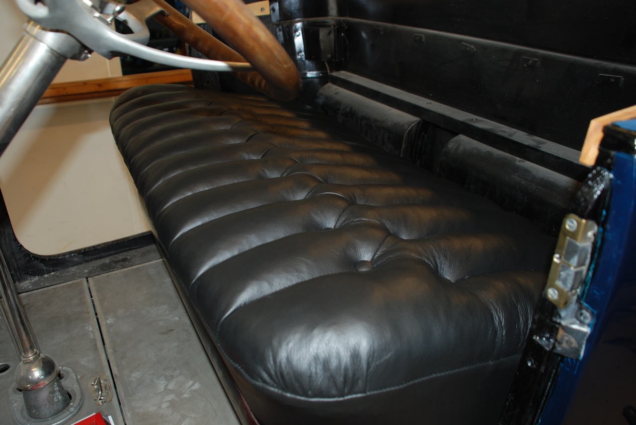 Forsetet, i sort skinn med «knapper» i polstringen